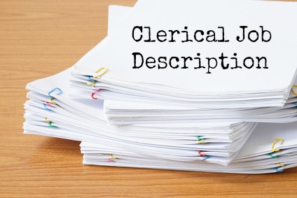 Documents with paperclips on a desk with words "Clerical Job Description"