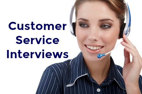 Female customer service agent with headset and writing "Customer Service Interviews"