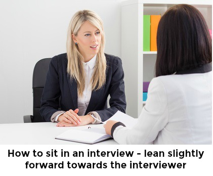 Woman leaning slightly forward towards interviewer with words 