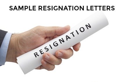 Man's hand holding resignation letter