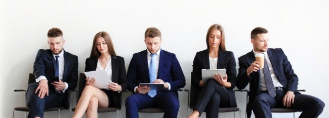 Five job candidates waiting in reception for an interview