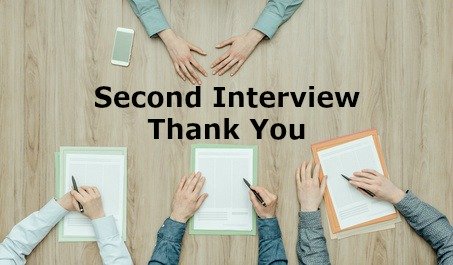 4 pairs of hands on desk with resumes and writing "second interview thank you"