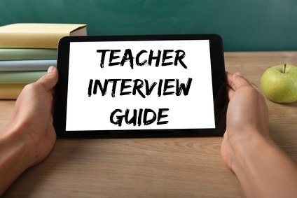 Teacher's hands holding tablet with words "Teacher Interview Guide" on tablet